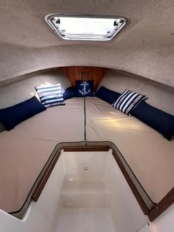 Slide: The Image of Cozy cabin interior of 1999 Atlas Boat Works Acadia 25 with nautical-themed pillows. - 14