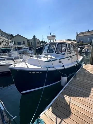 Slide: The Image of 1999 Atlas Boat Works Acadia 25 docked at marina under clear blue sky. - 5