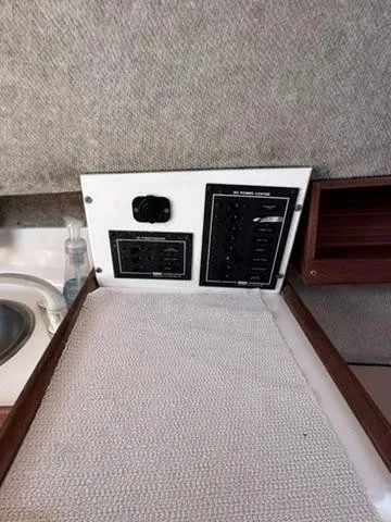 Slide: The Image of 1999 Atlas Boat Works Acadia 25 interior control panel and sink area. - 11