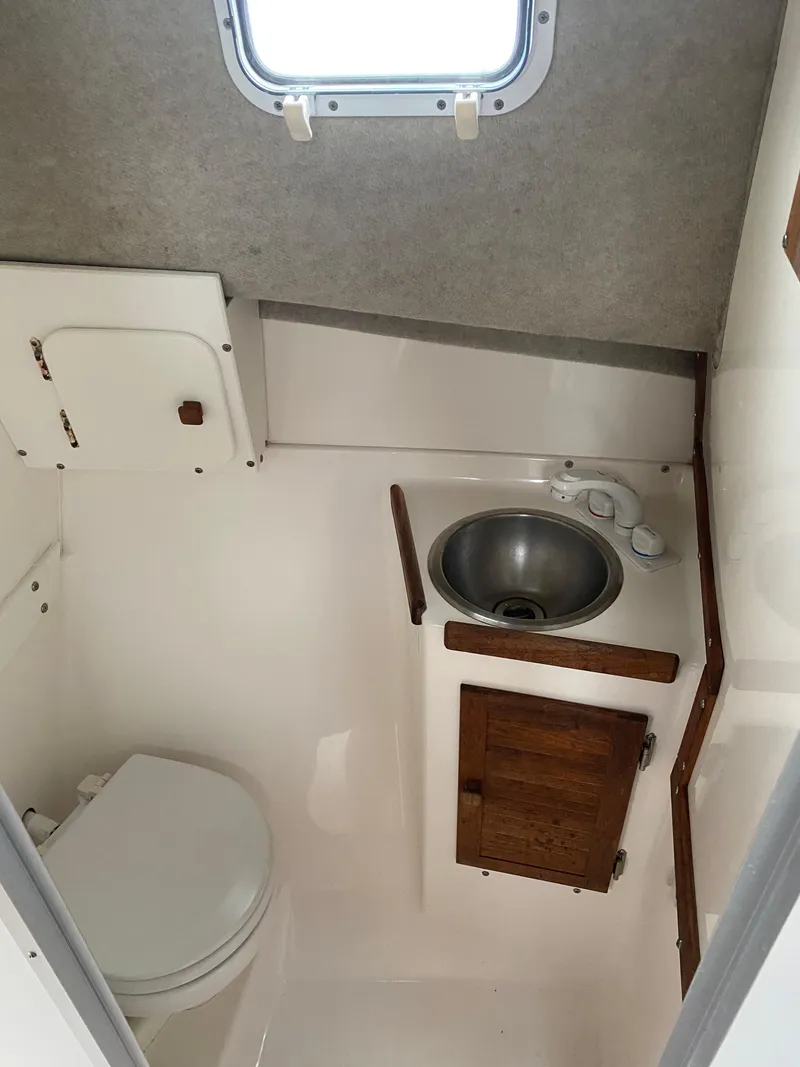 Slide: The Image of 1999 Atlas Boat Works Acadia 25 bathroom with sink and toilet. - 10