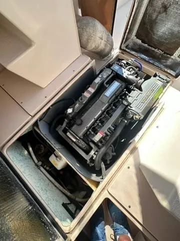 Slide: The Image of 1999 Atlas Boat Works Acadia 25 engine compartment, showcasing detailed mechanical components. - 16