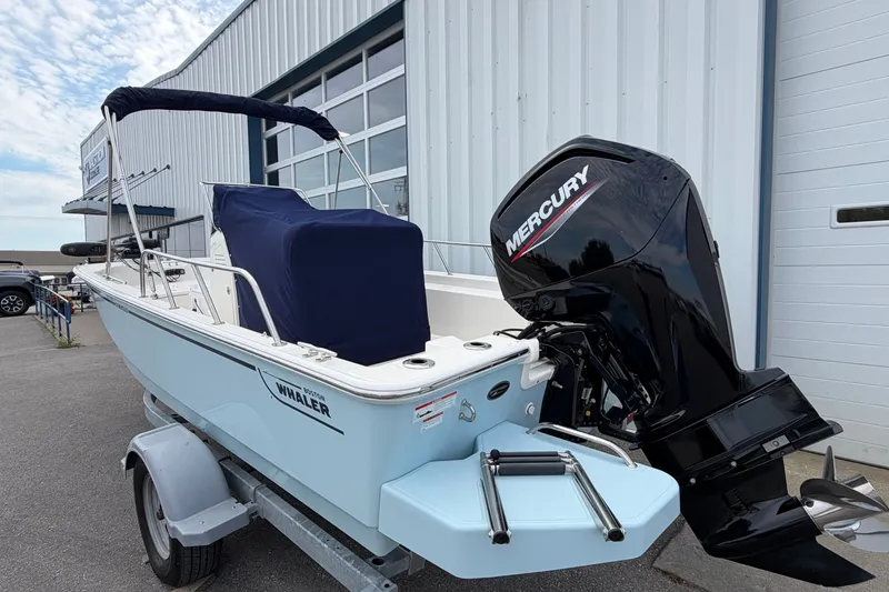 Slide: The Image of 2022 Boston Whaler 170 Montauk boat with Mercury engine on trailer, parked outside. - 4