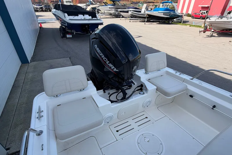 Slide: The Image of 2022 Boston Whaler 170 Montauk boat with Mercury engine, docked in a marina. - 14