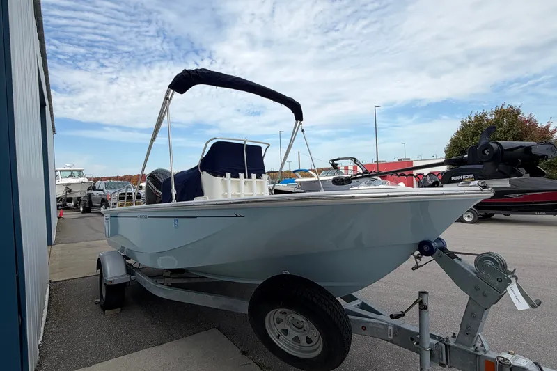 The Image of 2022 Boston Whaler 170 Montauk boat on trailer, parked outdoors under a cloudy sky. - 0