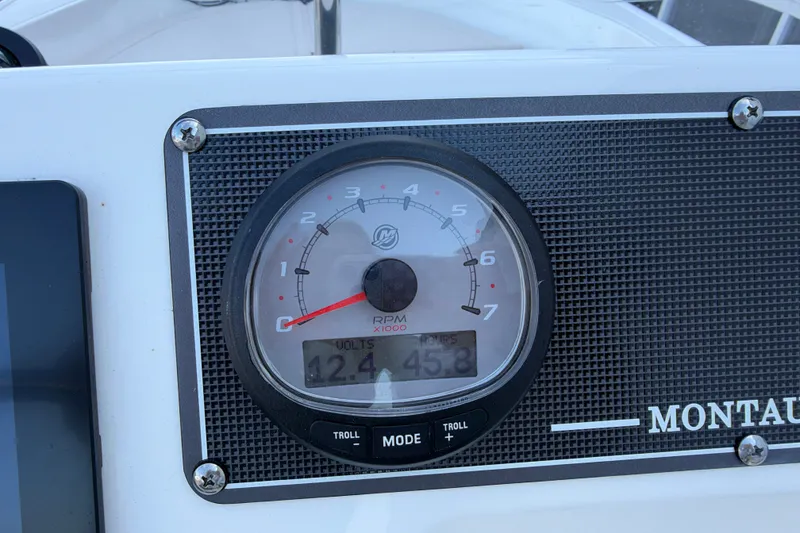 Slide: The Image of Dashboard of a 2022 Boston Whaler 170 Montauk showing RPM gauge and voltage display. - 16