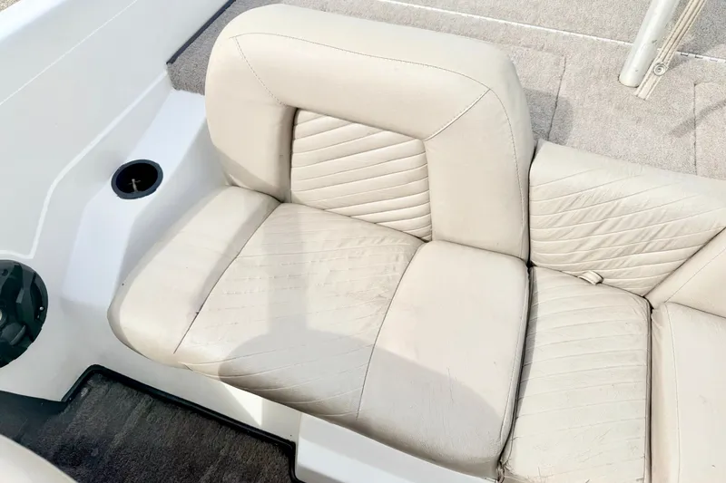 Slide: The Image of 1994 Skeeter SS140 boat seat with light beige upholstery and textured design. - 37