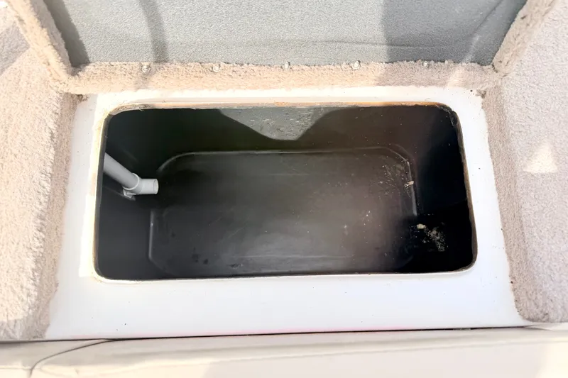 Slide: The Image of Open storage compartment in a 1994 Skeeter SS140 boat. - 29