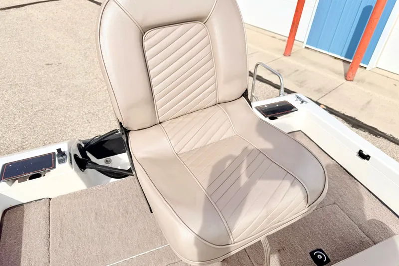 Slide: The Image of 1994 Skeeter SS140 boat seat with beige upholstery and textured design. - 27