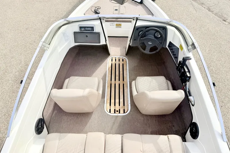 Slide: The Image of 1994 Skeeter SS140 boat interior with steering wheel, seats, and control panel. - 35