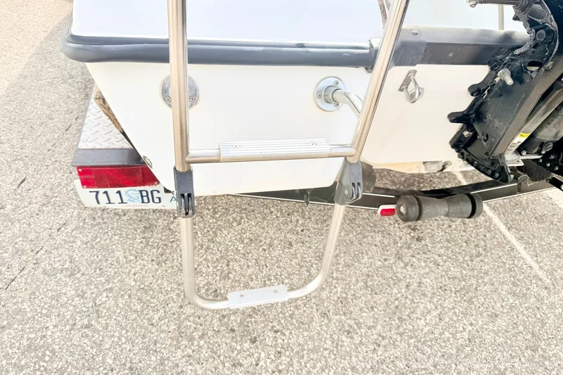 Slide: The Image of Rear view of a 1994 Skeeter SS140 boat with ladder and trailer. - 25