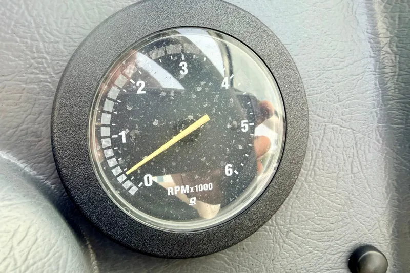Slide: The Image of Close-up of a 1994 Skeeter SS140 tachometer showing RPM x1000 gauge. - 44