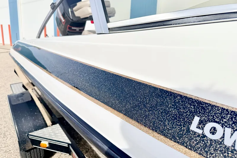 Slide: The Image of 1994 Skeeter SS140 boat close-up, showcasing sleek design and detailing on trailer. - 10