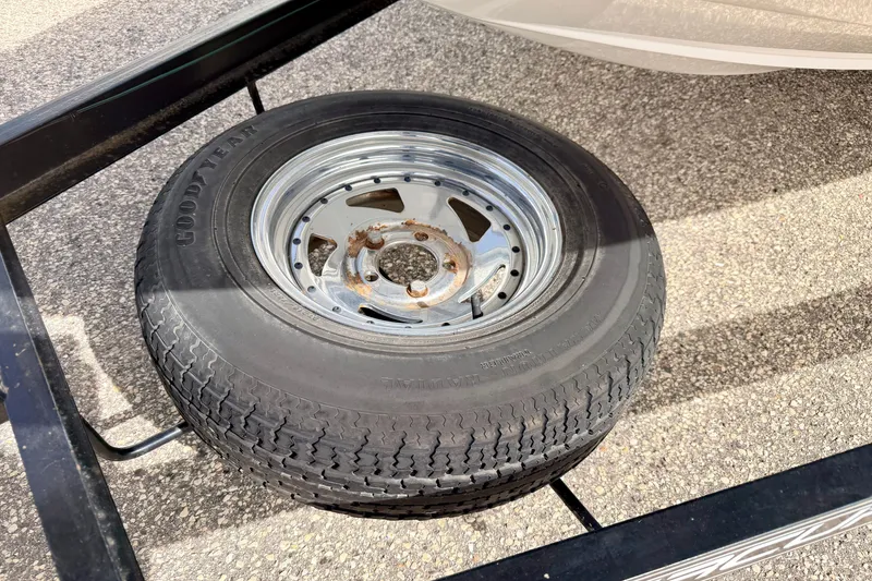 Slide: The Image of Spare tire on a 1994 Skeeter SS140 trailer, featuring a Goodyear tire and metal rim. - 72