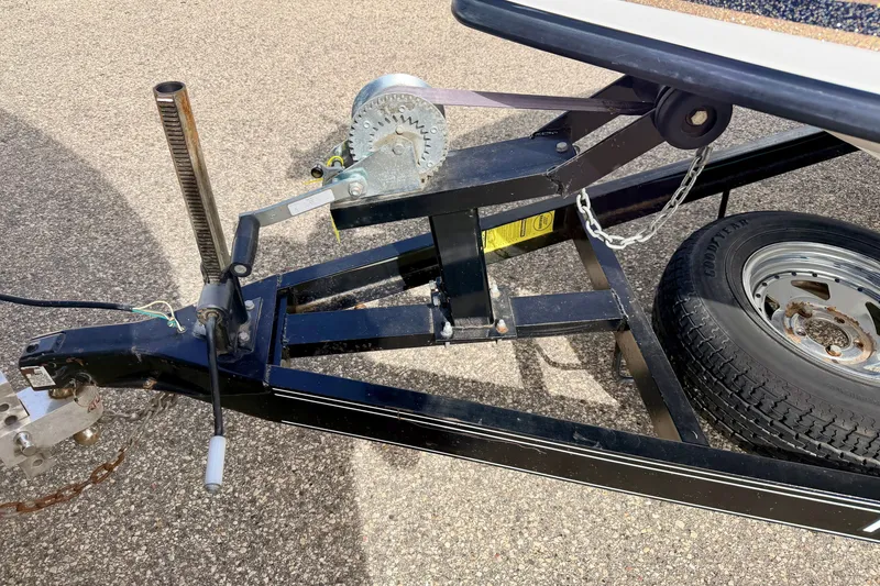 Slide: The Image of Trailer hitch and winch of a 1994 Skeeter SS140 boat on pavement. - 71