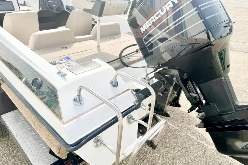 Slide: The Image of 1994 Skeeter SS140 boat with Mercury outboard motor and rear seating area. - 24