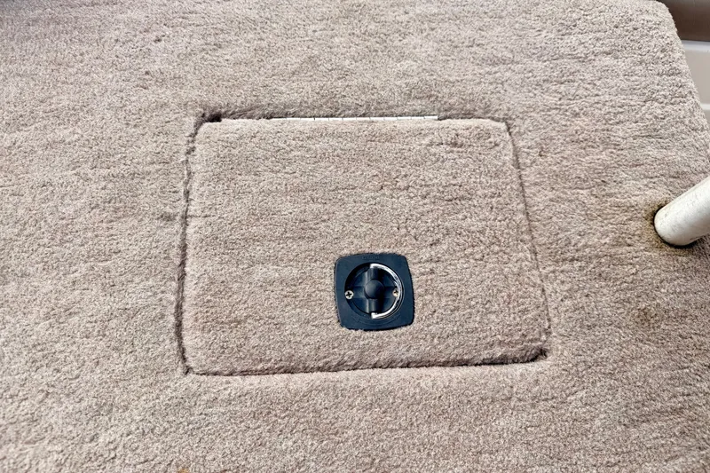 Slide: The Image of Carpeted hatch on a 1994 Skeeter SS140 boat deck with a metal latch. - 66