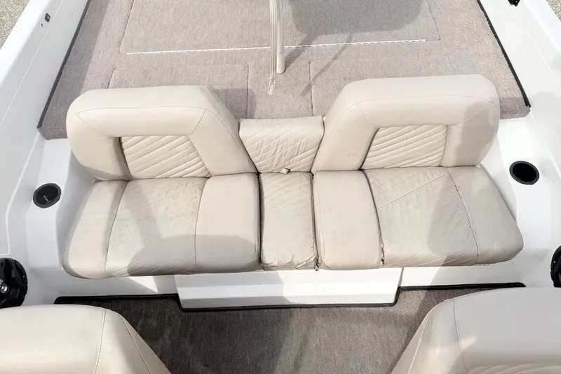 Slide: The Image of 1994 Skeeter SS140 boat interior with beige cushioned seating and carpeted flooring. - 36