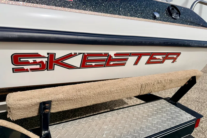 Slide: The Image of 1994 Skeeter SS140 boat with red logo and textured step platform. - 17