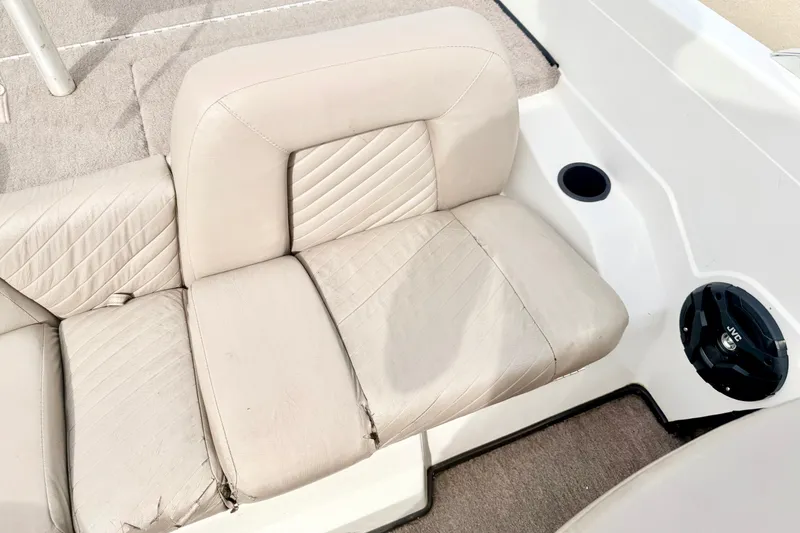 Slide: The Image of 1994 Skeeter SS140 boat interior with beige seating and JVC speaker. - 38