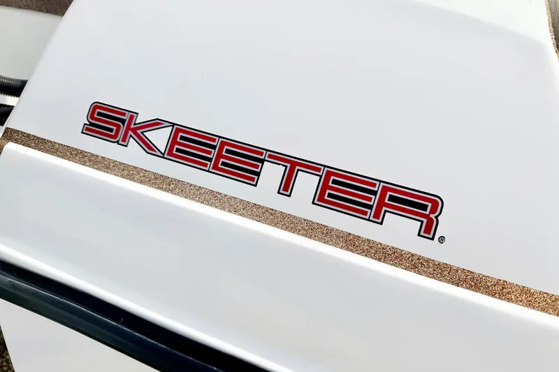 Slide: The Image of Close-up of 1994 Skeeter SS140 logo on white surface. - 14