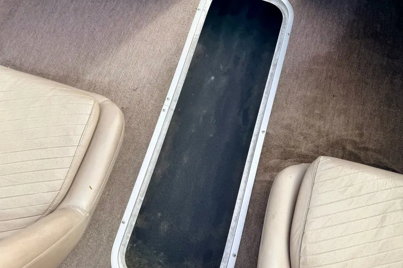 Slide: The Image of Interior of a 1994 Skeeter SS140 boat showing seats and carpeted flooring. - 51