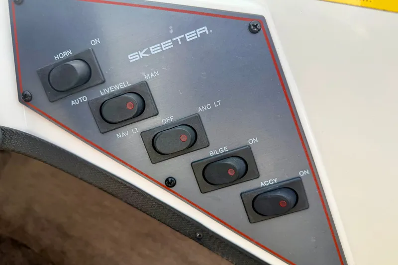Slide: The Image of Control panel of a 1994 Skeeter SS140 boat with various switches. - 45