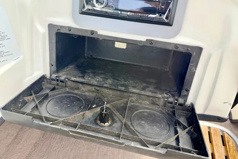 Slide: The Image of Open glove compartment in a 1994 Skeeter SS140 boat, showing interior details. - 49