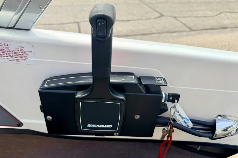 Slide: The Image of Throttle control lever on a 1994 Skeeter SS140 boat, featuring Quicksilver branding. - 46