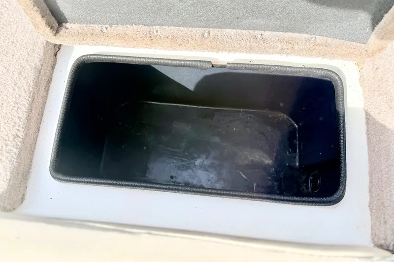 Slide: The Image of Open storage compartment in a 1994 Skeeter SS140 boat. - 31