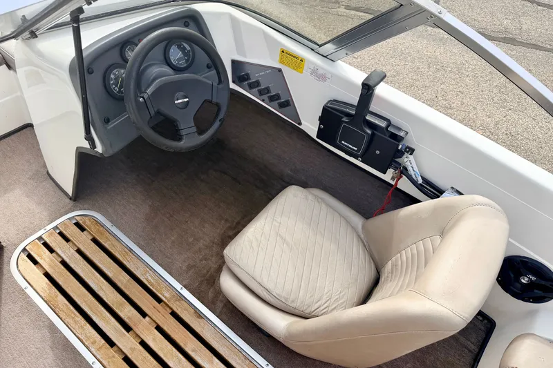 Slide: The Image of Interior of a 1994 Skeeter SS140 boat showing steering wheel and beige seat. - 41