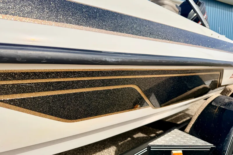 Slide: The Image of Close-up of 1994 Skeeter SS140 boat with glittery black and gold detailing. - 16