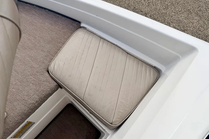 Slide: The Image of 1994 Skeeter SS140 boat interior with beige cushioned seat and carpeted flooring. - 56