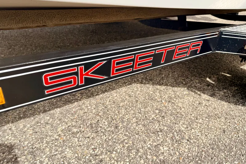 Slide: The Image of Close-up of 1994 Skeeter SS140 trailer with bold red logo on black frame. - 74