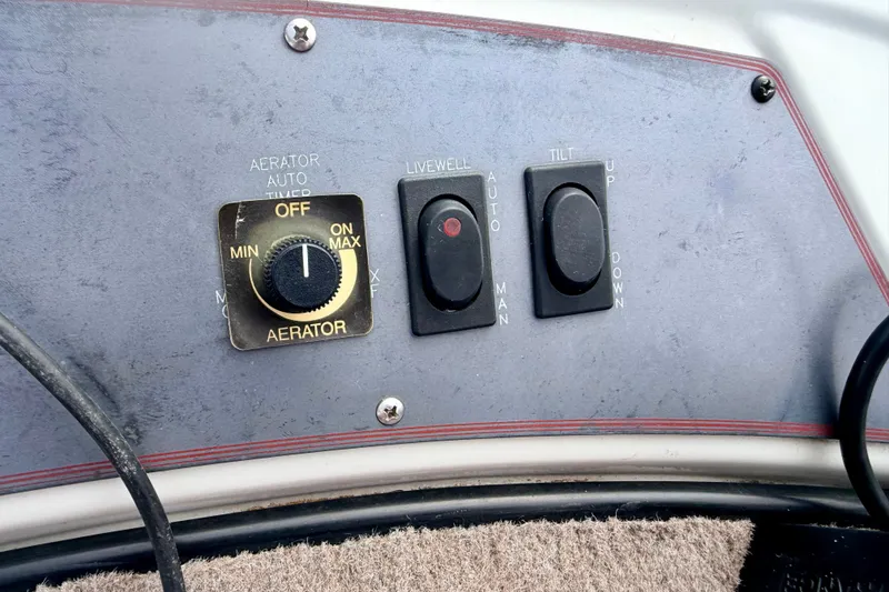 Slide: The Image of Control panel of a 1994 Skeeter SS140 boat with aerator and tilt switches. - 61