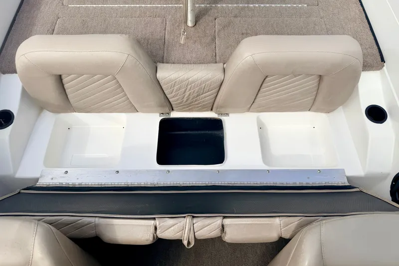 Slide: The Image of Interior seating of a 1994 Skeeter SS140 boat with beige upholstery. - 39