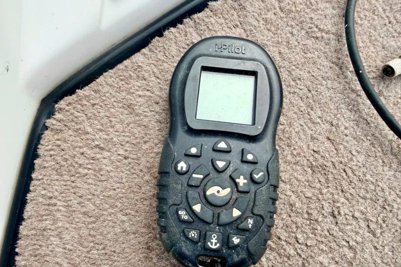 Slide: The Image of Remote control device on carpeted surface, likely for a 1994 Skeeter SS140 boat. - 58
