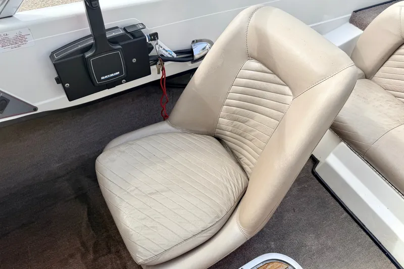 Slide: The Image of 1994 Skeeter SS140 boat interior with beige leather seat and control panel. - 40