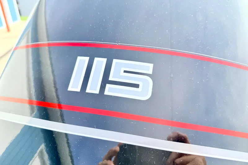 Slide: The Image of Close-up of 1994 Skeeter SS140 boat with '115' decal and red stripes. - 22