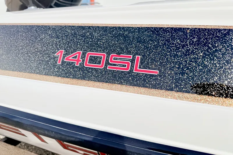 Slide: The Image of Close-up of 1994 Skeeter SS140 boat with "140SL" decal on glittery surface. - 8