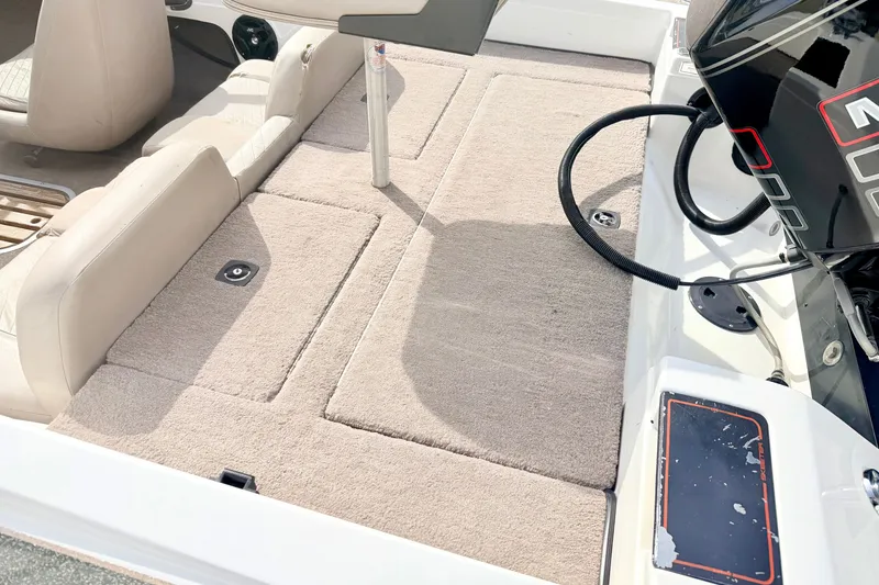 Slide: The Image of 1994 Skeeter SS140 boat interior with beige carpet and motor detail. - 26