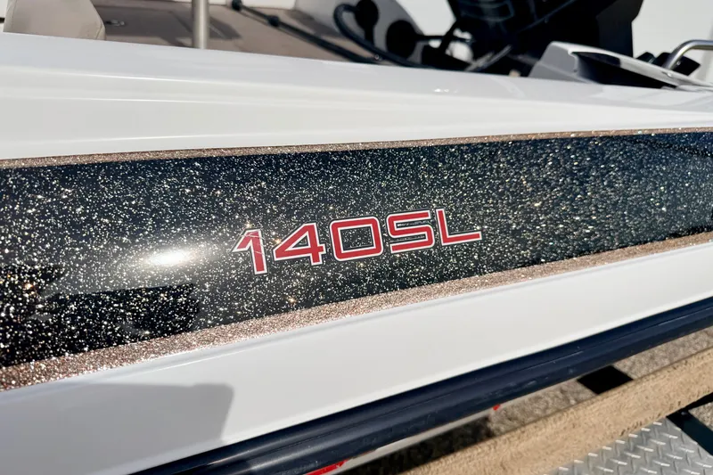 Slide: The Image of Close-up of 1994 Skeeter SS140 boat with glittery finish and "140SL" decal. - 18