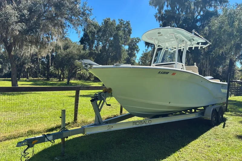 The Image of 2016 Sea Fox 246 Commander boat on trailer in a grassy area. - 0