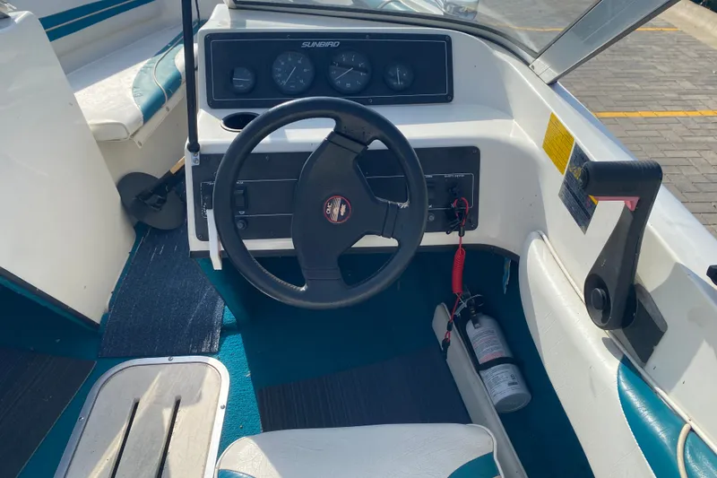 Slide: The Image of 1994 Sunbird Corsair 170 boat cockpit with steering wheel and dashboard controls. - 7