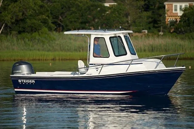The Image of 2027 Steiger Craft 21 Peconic boat on calm water, featuring sleek design and Yamaha engine. - 1