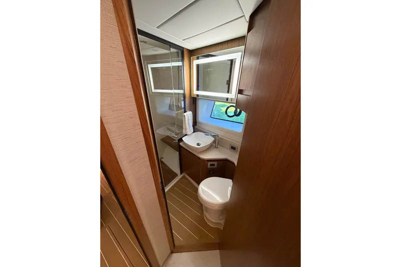 Slide: The Image of Luxurious bathroom in 2026 Tiara Yachts EX 54, featuring modern fixtures and elegant wood finishes. - 15