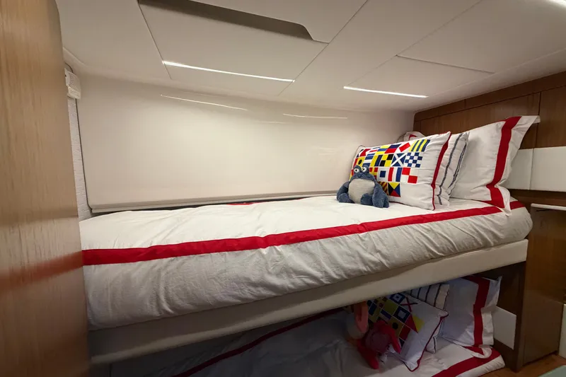 Slide: The Image of Luxurious 2026 Tiara Yachts EX 54 cabin with nautical-themed bedding and plush toy. - 19