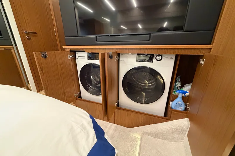 Slide: The Image of Laundry area with washer and dryer in 2026 Tiara Yachts EX 54 interior. - 24
