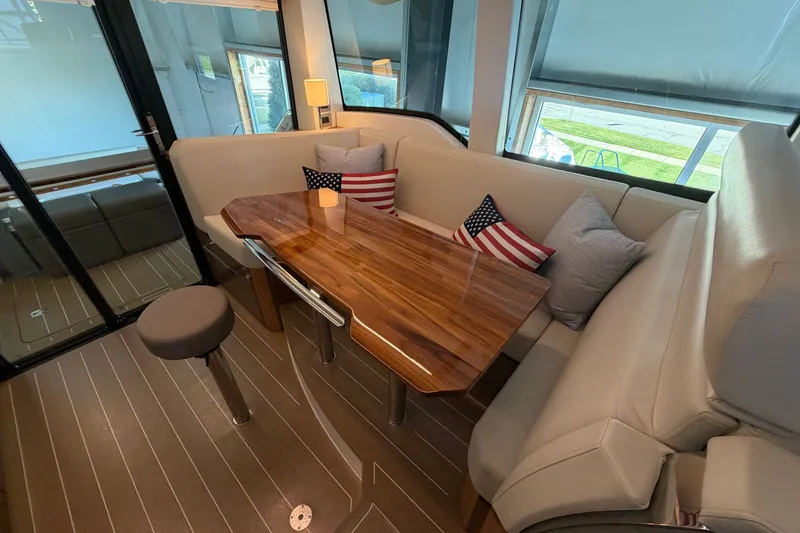 Slide: The Image of Luxurious interior of 2026 Tiara Yachts EX 54 with elegant seating and wooden table. - 17