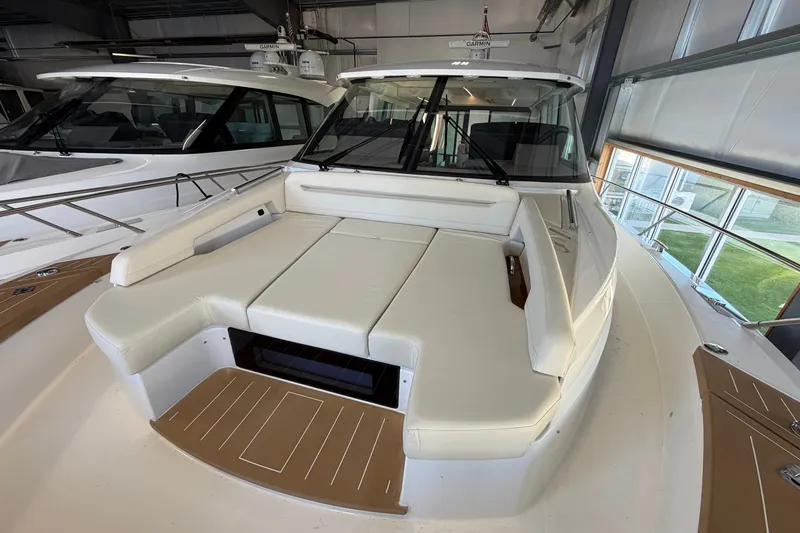 Slide: The Image of 2026 Tiara Yachts EX 54 luxury yacht interior with white seating and modern design. - 34