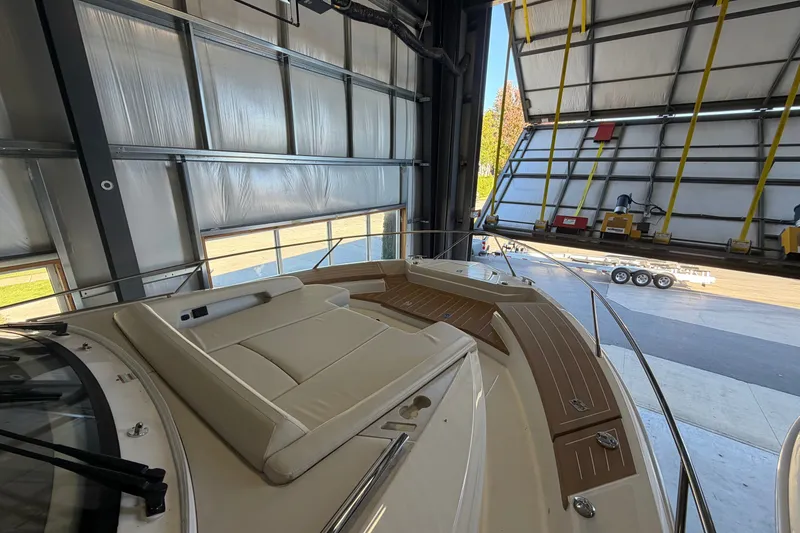 Slide: The Image of 2026 Tiara Yachts EX 54 in a boatyard, showcasing luxurious deck seating. - 35